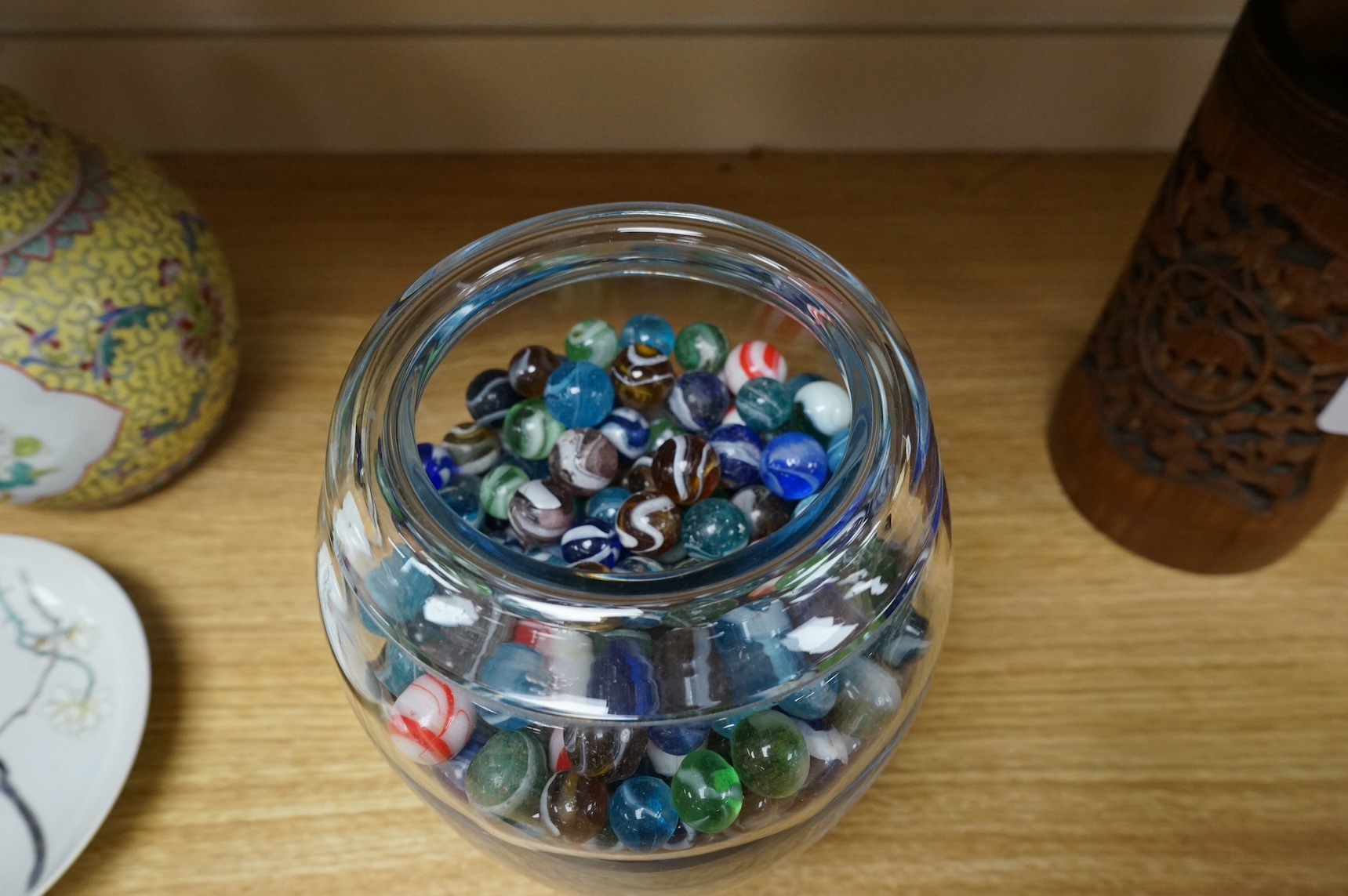 A glass vase possibly by Holmgaard, containing a large collection of late 19th/early 20th century glass marbles, 19cm high